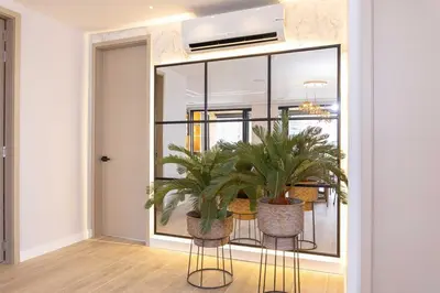 a room with a table and two potted plants at Exclusive Luxury Apartment - Poblado Medellín in Medellín