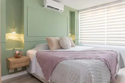 a bedroom with a bed with a pink blanket at Exclusive Luxury Apartment - Poblado Medellín in Medellín