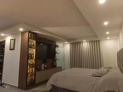 a bedroom with a bed and a book shelf at Penthouse with Jacuzzi in Guarne in Guarne
