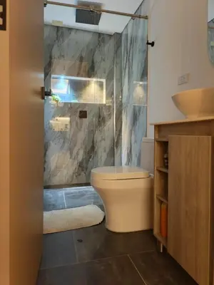 a bathroom with a shower and a toilet and a sink at Penthouse with Jacuzzi in Guarne in Guarne