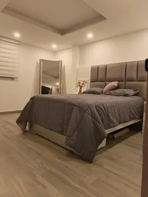 a bedroom with a large bed and a mirror at Penthouse with Jacuzzi in Guarne in Guarne