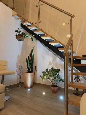 a spiral staircase in a room with potted plants at Penthouse with Jacuzzi in Guarne in Guarne