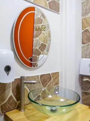 a bathroom with a glass bowl sink on a counter at S23 I City Lodge in Sabaneta