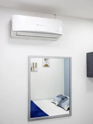 a mirror in a room with a bed at S23 I City Lodge in Sabaneta