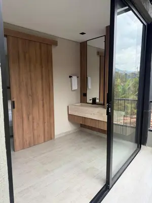 a bathroom with a large sliding glass door and a sink at Moderno y luminoso apartamento de 3 habitaciones 314 in Medellín