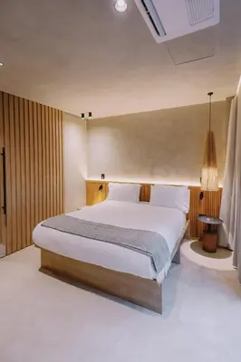 a bedroom with a large bed in a room at Kuuna Medellín By Be Host in Medellín