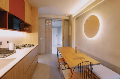 a kitchen and dining room with a wooden table and chairs at Kuuna Medellín By Be Host in Medellín