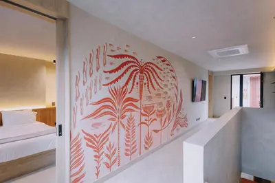 a bedroom with a painting on the wall at Kuuna Medellín By Be Host in Medellín