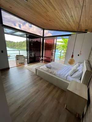 a bedroom with a bed and a large window at Boreal Glamping in Guatapé