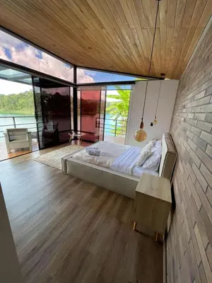 a bedroom with a bed and a large window at Boreal Glamping in Guatapé