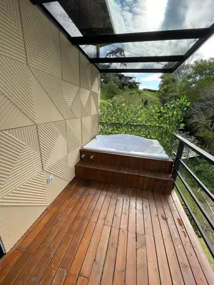 a hot tub sitting on a wooden deck at Boreal Glamping in Guatapé