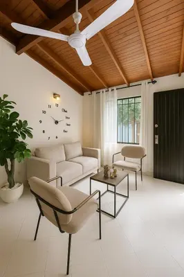 a living room with a couch and a clock on the wall at Casa Bosques in Pilarica - Family and cozy in Medellín