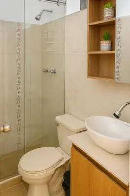 a bathroom with a toilet and a sink at Casa Bosques in Pilarica - Family and cozy in Medellín