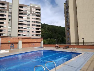 a large swimming pool with two tall buildings at Perfect place to relax! in Medellín