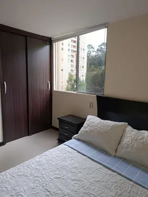 a bedroom with a bed and a large window at Perfect place to relax! in Medellín