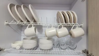 a rack with cups and plates and glasses in a kitchen at Plaza Corales Manizales in Manizales
