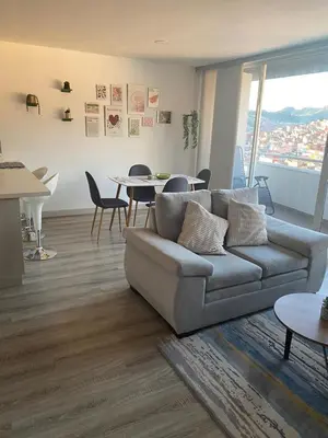 a living room with a couch and a table at Plaza Corales Manizales in Manizales