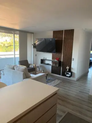 a living room with couches and a flat screen tv at Plaza Corales Manizales in Manizales