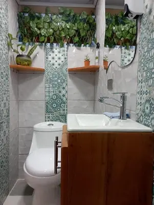 a bathroom with a sink and a toilet and a mirror at Cabaña El Jericoano in Jericó