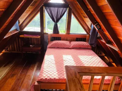 a bedroom with a bed in a attic at Cabaña El Jericoano in Jericó