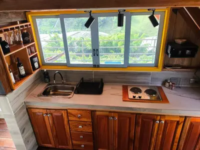 a kitchen with a sink and a window at Cabaña El Jericoano in Jericó