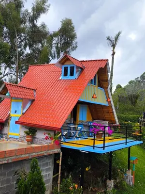 a house with an orange roof with a boat in front at Cabaña El Jericoano in Jericó