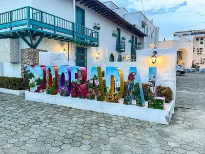 a sign that says garden in front of a building at Apartahotel in Doradal