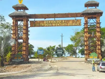 a gate in the middle of a road with a sign at Apartahotel in Doradal