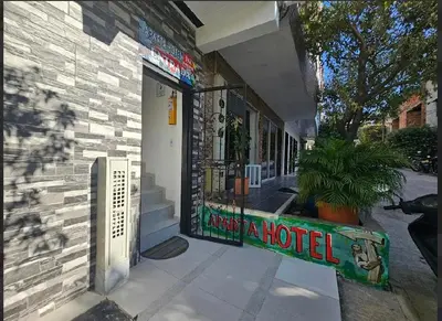 a building with a sign that reads trust a hotel at Apartahotel in Doradal