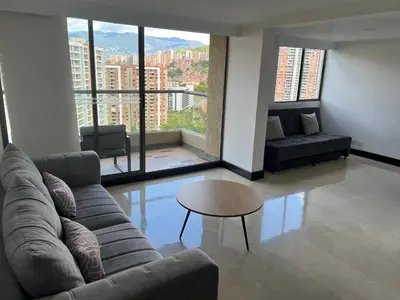 a living room with a couch and a table at Apartamento Medellín in Medellín