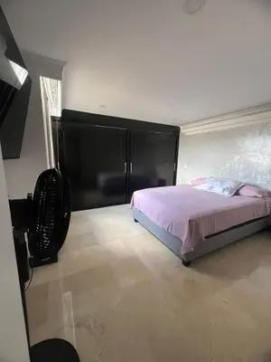 a bedroom with a bed with a large black headboard at Apartamento Medellín in Medellín