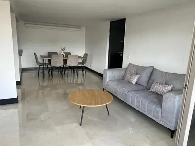 a living room with a couch and a table at Apartamento Medellín in Medellín
