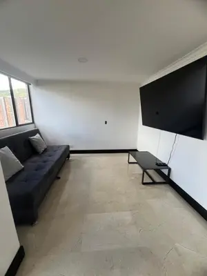 a living room with a couch and a chair at Apartamento Medellín in Medellín