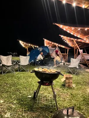 a grill with people sitting in chairs in a tent at Conexión naturaleza in San Luis