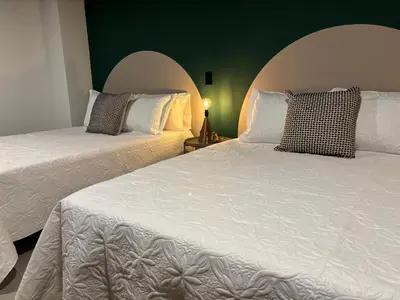 two beds sitting next to each other in a room at Moore 45 Tu Espacio Comodo en Medellín in Medellín