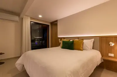 a bedroom with a large white bed and a window at 202 Modern Stay in Laureles Area Cozy Balcony AC in Medellín