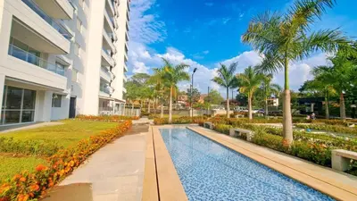 a swimming pool in front of a building at Agradable y confortable apto vacacional en Santa Fé de Antioquia-Colombia dentro de condominio con piscina, tobogán, zonas recreativas, jardines y espectacular vista in Santa Fe de Antioquia