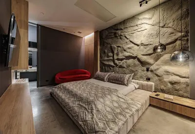 a bedroom with a bed and a stone wall at Luxurious Farm House Finca Libia in Guarne