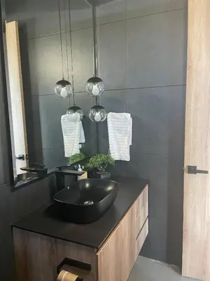 a bathroom with a black sink and a mirror at Luxurious Farm House Finca Libia in Guarne