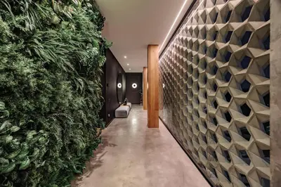 a hallway with a wall of green plants at Luxurious Farm House Finca Libia in Guarne