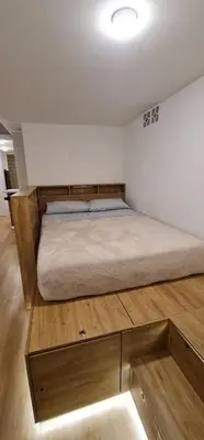a bedroom with a bed and a wooden cabinet at Nomad Studio el Cable in Manizales