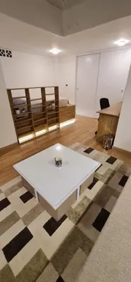 a white coffee table in a room with a rug at Nomad Studio el Cable in Manizales
