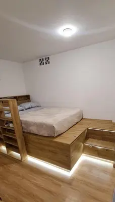 a bedroom with a bed with a wooden bed frame at Nomad Studio el Cable in Manizales