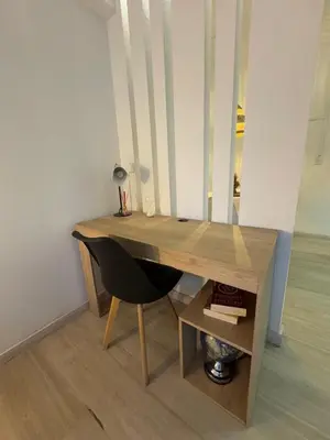 a wooden desk with a chair next to a table at Loft moderno en el Poblado con Aire acondicionado in Medellín