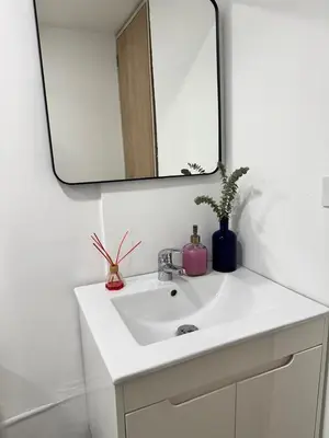 a bathroom with a white sink and a mirror at Loft moderno en el Poblado con Aire acondicionado in Medellín