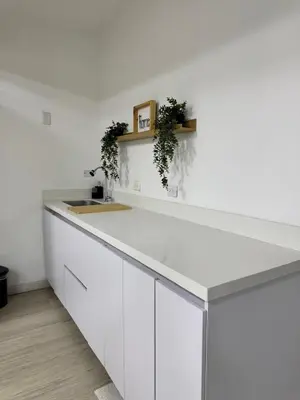 a white kitchen with a counter and a sink at Loft moderno en el Poblado con Aire acondicionado in Medellín