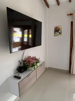a living room with a flat screen tv on a wall at Las Flores de María 302 in Jardin