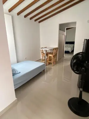 a bedroom with a bed and a table and chairs at Las Flores de Mria 304 in Jardin