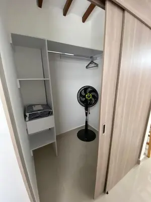 a walk in closet with a fan in a room at Las Flores de Mria 304 in Jardin