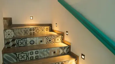 a staircase with tiled floors and a green rail at Loft Moderno junto al Monasterio de Jericó in Jericó